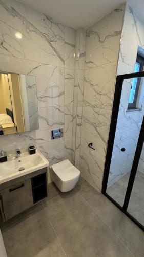 a bathroom with a sink and a toilet and a shower at Villa Lea - 4 km to the sea 9 km to the airport in Antalya