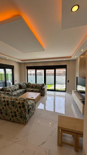 a large living room with a couch and a tv at Villa Lea - 4 km to the sea 9 km to the airport in Antalya