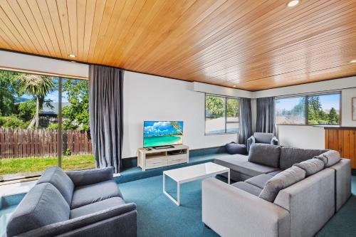 a living room with two couches and a tv at 43 Conical Hill Road in Hanmer Springs