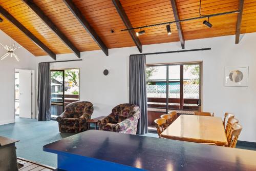 a living room with a table and chairs at 43 Conical Hill Road in Hanmer Springs