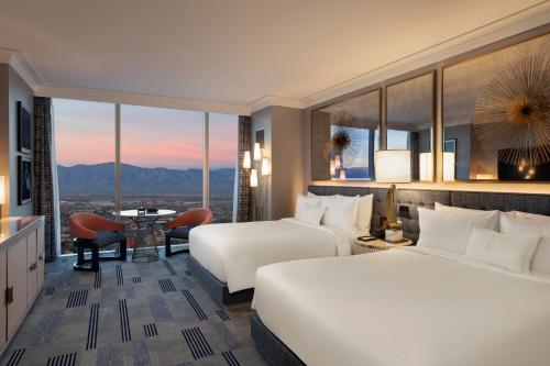 two beds in a hotel room with a view at Fontainebleau Las Vegas in Las Vegas