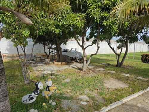 a group of stuffed animals in a yard with trees at Chácara Urbana in Juazeiro