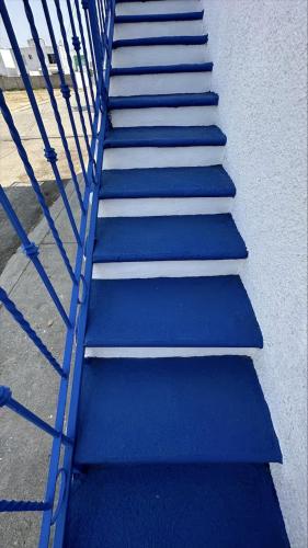a set of blue stairs next to a building at CASA DORADO A con AC Y SMART TV Planta Alta in Mezcales