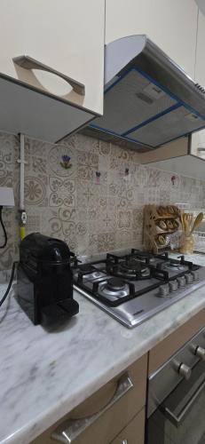 a kitchen counter with a stove top in a kitchen at Loft of joy La Soukra in La Soukra