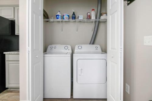 two washing machines in a laundry room with at Suite Carolina in Charleston