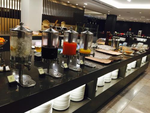 a buffet line with different types of food on plates at Seoul Garden Hotel in Seoul