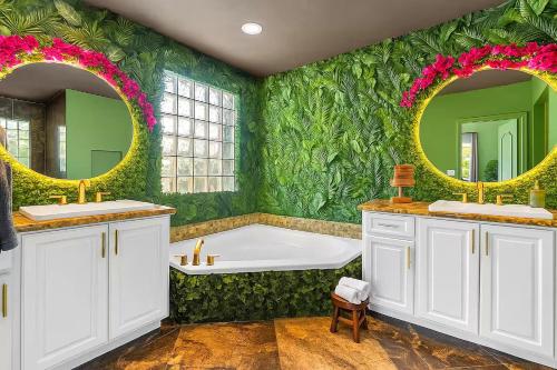 a green bathroom with a tub and two mirrors at Avatar Miami Villa - Heated Pool & Spa - Pickleball & Cinema in Hammocks