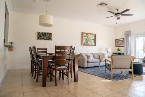 a dining room and living room with a table and chairs at NEW Oceanfront Condo in George Town in George Town