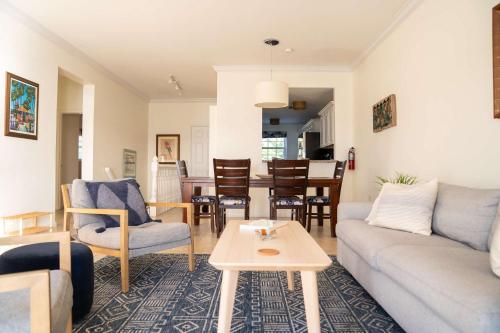 a living room with a couch and a table at NEW Oceanfront Condo in George Town in George Town