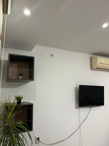 a living room with a tv on a white wall at Stella 2 Apartment in Negotino