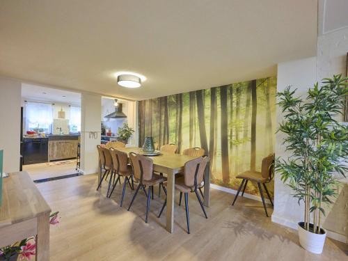 a dining room with a table and chairs at Landsraderhöfke - 1 in Heijenrath
