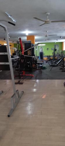 a gym with a lot of exercise equipment in it at Hostel Barracudas in Tampico