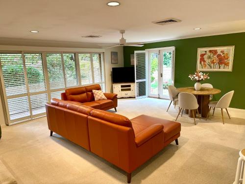 a living room with a couch and a table at Centrally located Stylish Villa on the Hill in Albury