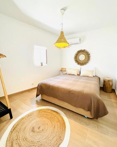 a bedroom with a large bed and a rug at Casa Fidalgo in Santo António da Terrugem