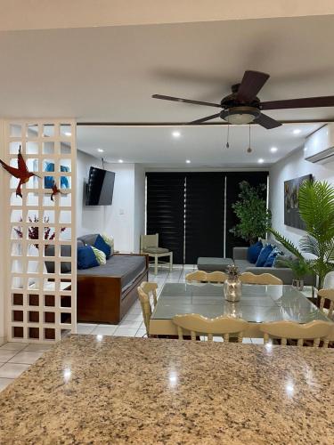 a living room with a ceiling fan and a table at Marina del Sol Resort - beautiful 2 bdrm Sleeps 8 -Ocean front in Mazatlán
