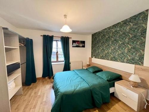 une chambre avec un lit avec des draps bleus et une fenêtre dans l'établissement Gîte authentique avec terrasse couverte, 16 km de Gérardmer, 4 chambres, équipement bébé, Wi-Fi inclus - FR-1-589-231, à Aumontzey