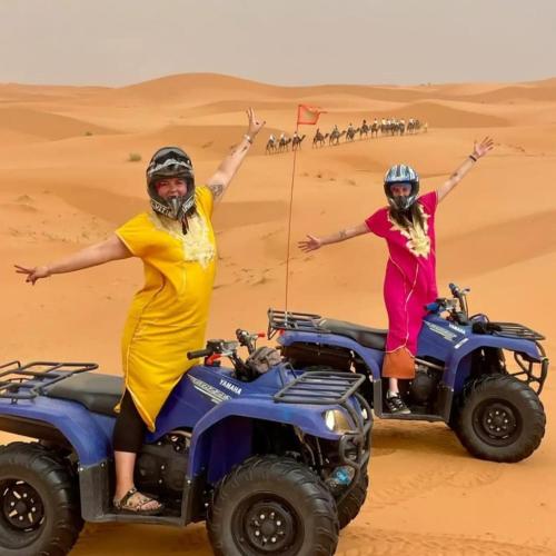 two women on a jeep in the desert at Merzouga Best Luxury Camp in Merzouga