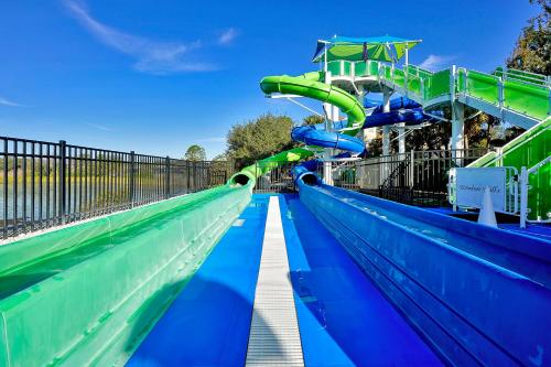 a water slide in an amusement park with blue and green at Summer is Calling - Disney Close - No Resort Fees in Orlando