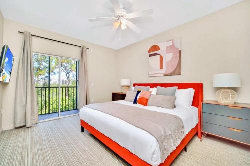 Un dormitorio con una cama grande y una ventana. en Modern 2BR Condo - Hot Tub and Pool - Near Disney, en Orlando