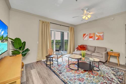 a living room with a couch and a table at 2BR Condo with Hot tub and pool, near Disney! in Orlando