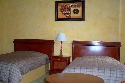 a hotel room with two beds and a table at Pałac Brody in Brody