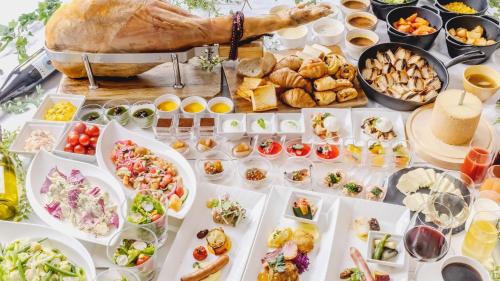 a table filled with lots of appetizers and food at Premier Hotel Nakajima Park Sapporo in Sapporo