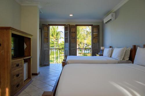 Ένα ή περισσότερα κρεβάτια σε δωμάτιο στο Vila Angatu Eco Resort SPA