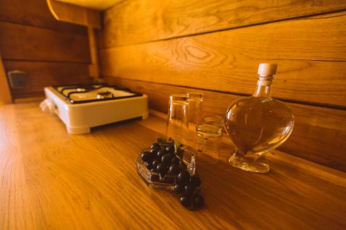 a bottle of wine and a glass on a table at River huts Zrmanja in Obrovac
