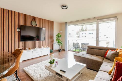 a living room with a couch and a tv at The Stalle in Brussels