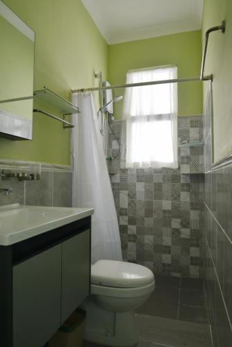 a bathroom with a toilet and a sink and a shower at Rafiki Homestay in Kota Kinabalu