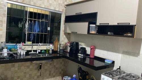 a kitchen with a sink and a counter top at Casa para Rondônia Rural Show in Ji-Paraná