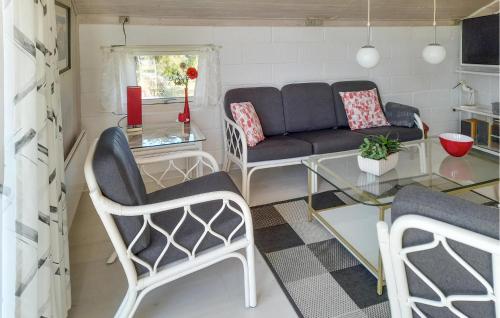 a living room with a couch and a glass table at Holiday Home Grårisvej Thisted V in Nørre Vorupør