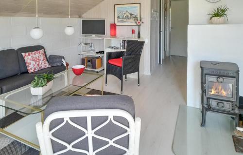 a living room with a couch and a fireplace at Holiday Home Grårisvej Thisted V in Nørre Vorupør