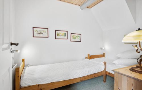 a bedroom with a bed with white sheets and a lamp at Two-Bedroom Apartment In Middelfart in Middelfart