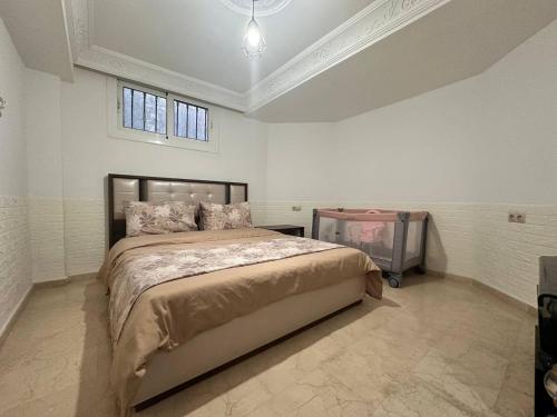 a bedroom with a large bed in a white room at La casabella in Tangier