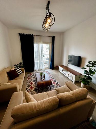 a living room with a couch and a bed at امواج شاليه فندقي Amwaj north coast 2 bedroom in El Alamein