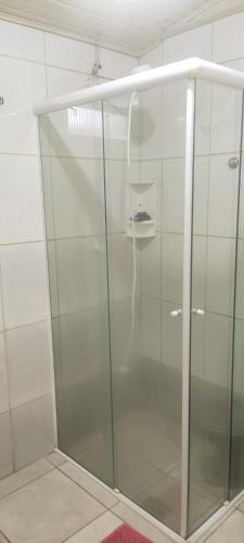 a shower with a glass door in a bathroom at Casa Lagoa Santo Antônio in Laguna