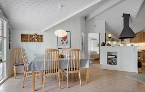 a kitchen and dining room with a table and chairs at Three-Bedroom Holiday Home In Assens in Assens