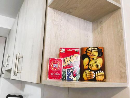 a kitchen cabinet with some snacks on a shelf at Apartamento cerca de Solca y Embajada, turismo, trabajo, gimnasio, con vista al Cotopaxi in Hacienda Farsalia
