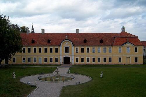 a large building with a fountain in front of it at Pałac Brody in Brody