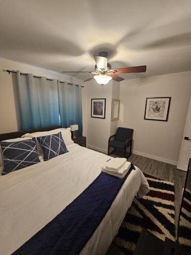 a bedroom with a bed and a ceiling fan at Aansel Suites 2 bedroom in Edmonton