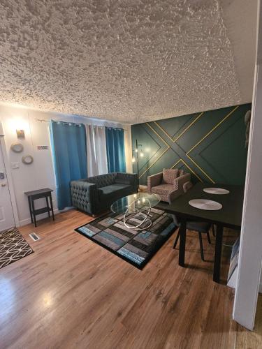 a living room with a table and a couch at Aansel Suites 2 bedroom in Edmonton