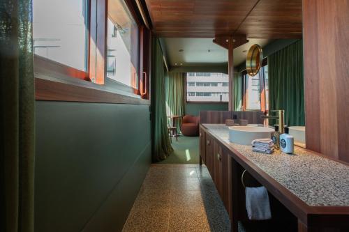a bathroom with a counter with a sink in it at Hyde Melbourne Place in Melbourne