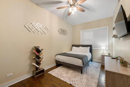 a bedroom with a bed and a ceiling fan at Medical District 2BR with Jacuzzi & Parking in Chicago