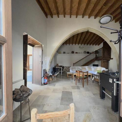 a living room with an archway and a table and chairs at The Family Nest - Traditional Serenity in Nicosia
