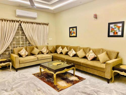a living room with a couch and a table at Travis Executive Guest House Islamabad in Islamabad