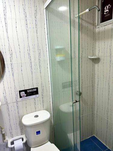 a bathroom with a toilet and a glass shower at GRAN HORIZON RODADERO Santa Marta in Santa Marta