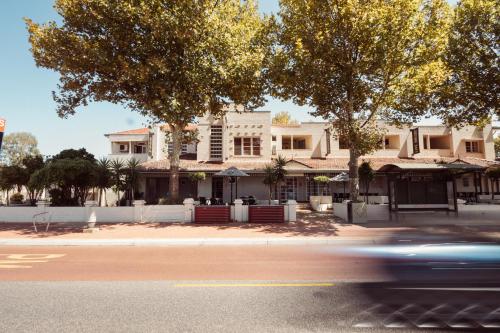 a car driving down a street in front of a house at Civic Hotel in Perth