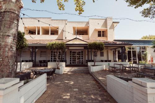 a house with tables and chairs in front of it at Civic Hotel in Perth