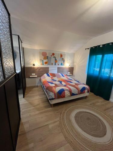 a bedroom with a bed and a rug in it at Maison entièrement rénovée, jardin & terrasse à 5min des plages in Combrit